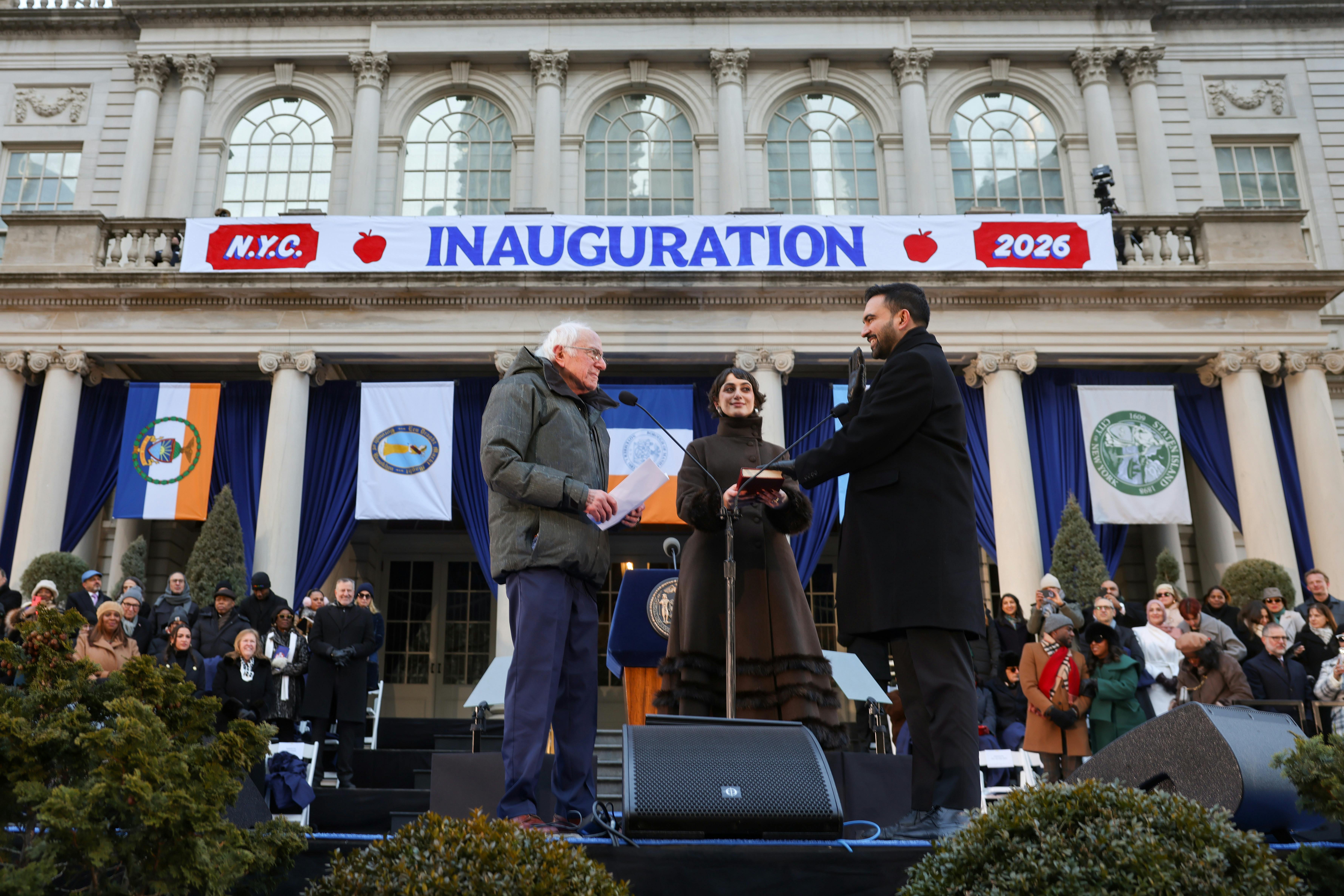 New York City Mayor Zohran Mamdani stands next to his wife Rama Duwaji as Vermont Senator Bernie Sanders swears him in