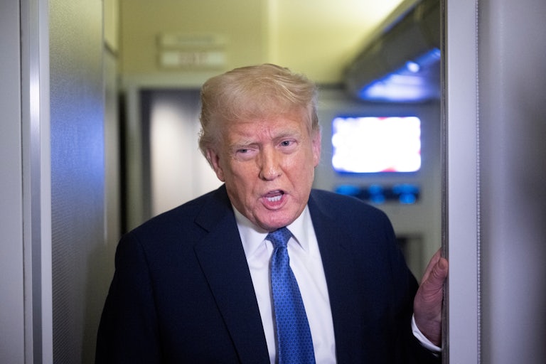Donald Trump speaks to reporters on Air Force One