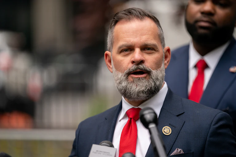 Representative Cory Mills speaks into a microphone