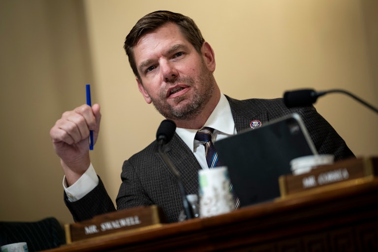 Eric Swalwell gestures with a pen as he speaks