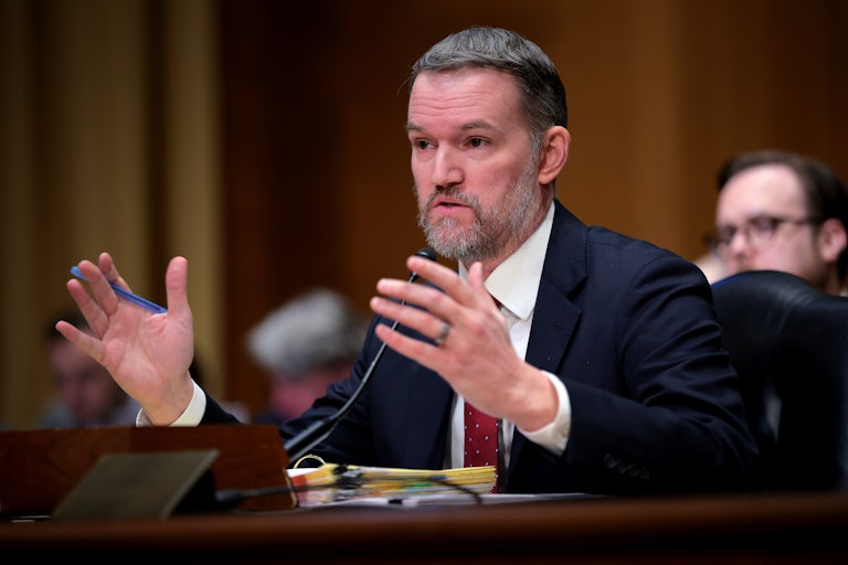 Trade Representative Jamieson Greer gestures while speaking into a microphone during a Senate Hearing