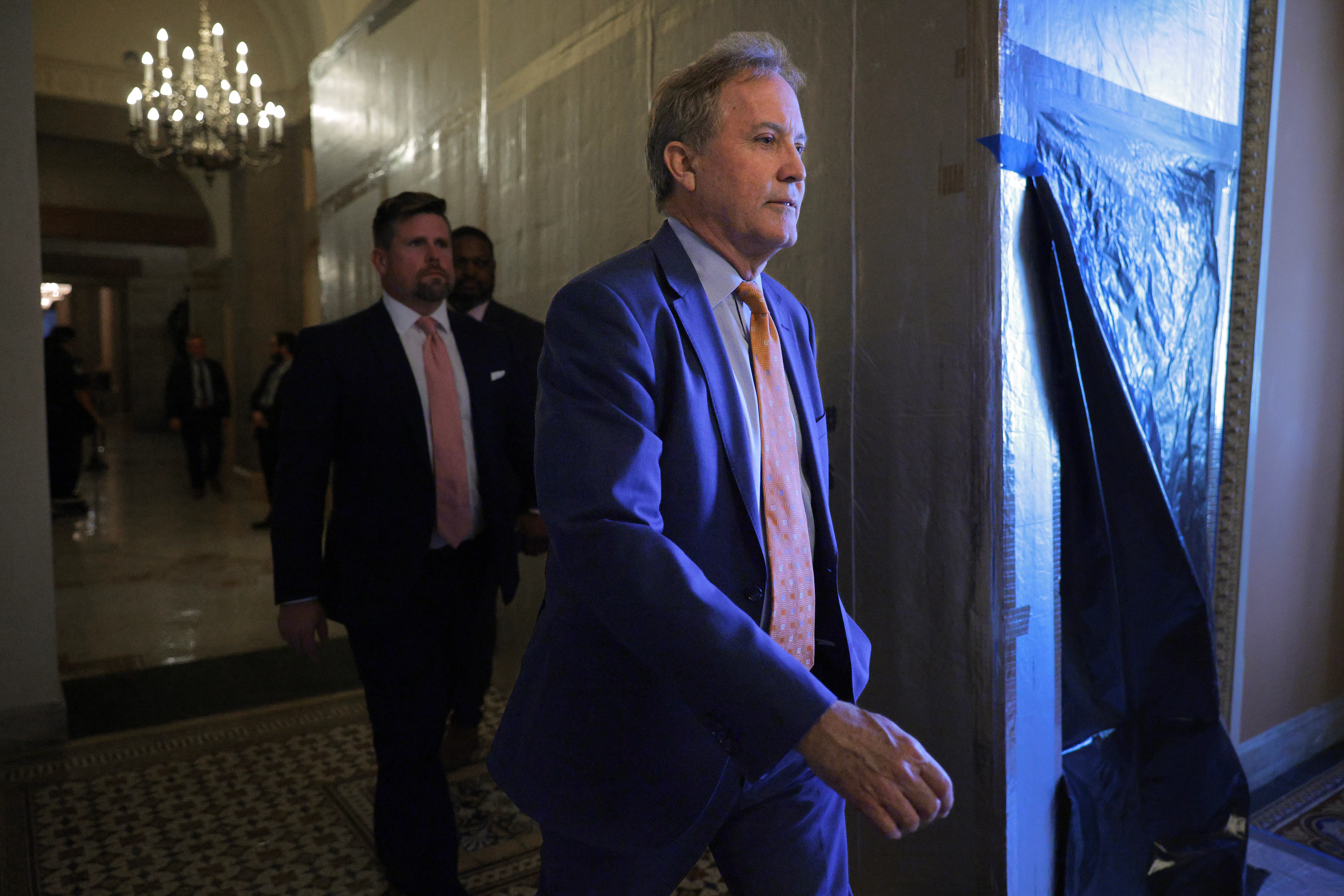 Texas Attorney General Ken Paxton walks in the Capitol