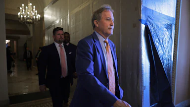 Texas Attorney General Ken Paxton walks in the Capitol