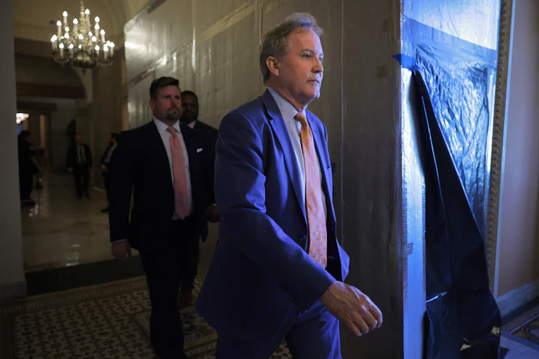Texas Attorney General Ken Paxton walks in the Capitol