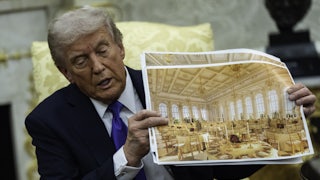 Donald Trump speaks and holds up renderings of his ballroom while sitting in the Oval Office