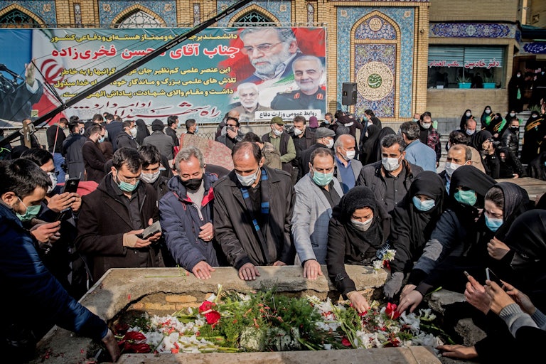 Iranian mourners attend the burial ceremony of nuclear scientist Mohsen Fakhrizadeh.
