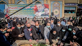 Iranian mourners attend the burial ceremony of nuclear scientist Mohsen Fakhrizadeh.