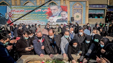 Iranian mourners attend the burial ceremony of nuclear scientist Mohsen Fakhrizadeh.