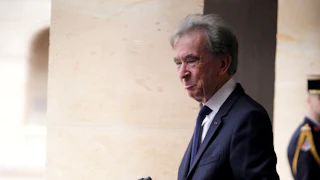 Bernard Arnault, billionaire and chairman of LVMH Moet Hennessy Louis Vuitton SE, photographs his alma mater at a ceremony to mark the funding of a new math research institute at Les Invalides, in Paris, France.