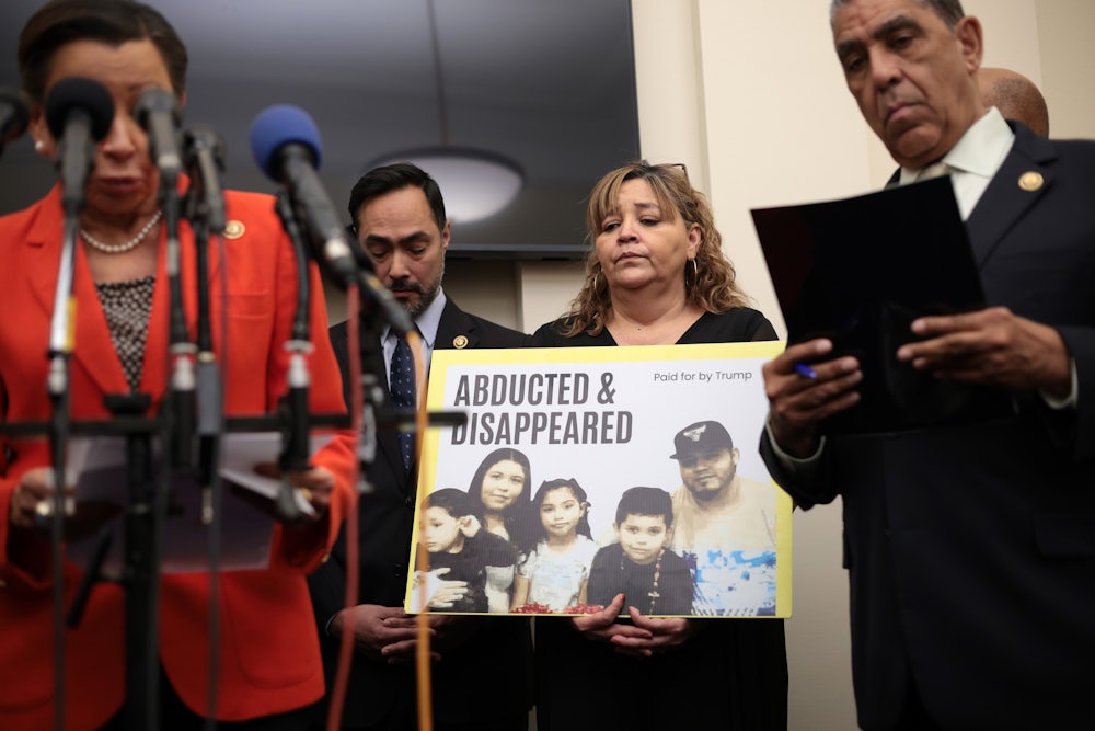 The mother of Kilmar Abrego Garcia holds a picture of her son and his family during a news conference to discuss his son's arrest and deportation in Washington, D.C.