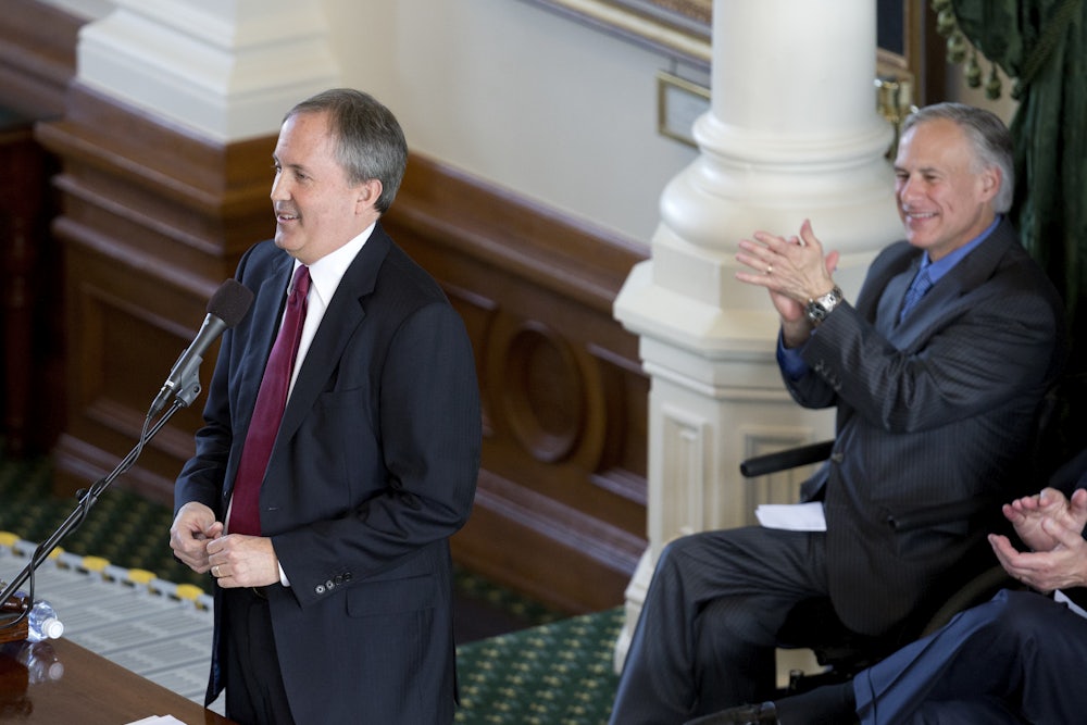 As Governor Greg Abbott applauds, Texas Attorney General Ken Paxton takes the oath of office January 5, 2015 as Texas' head law enforcement officer.