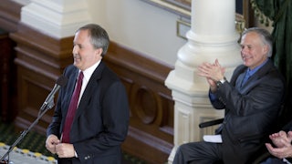 As Governor Greg Abbott applauds, Texas Attorney General Ken Paxton takes the oath of office January 5, 2015 as Texas' head law enforcement officer.