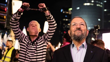 Ehud Barak, former prime minister of Israel, listens to a speech