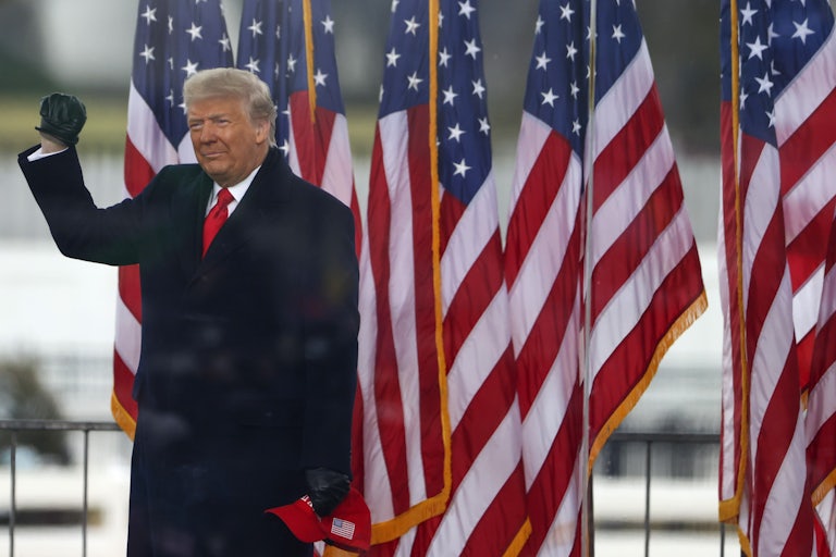 Donald Trump waves to the crowd at a "Stop the Steal" rally shortly before rioters stormed the United States Capitol