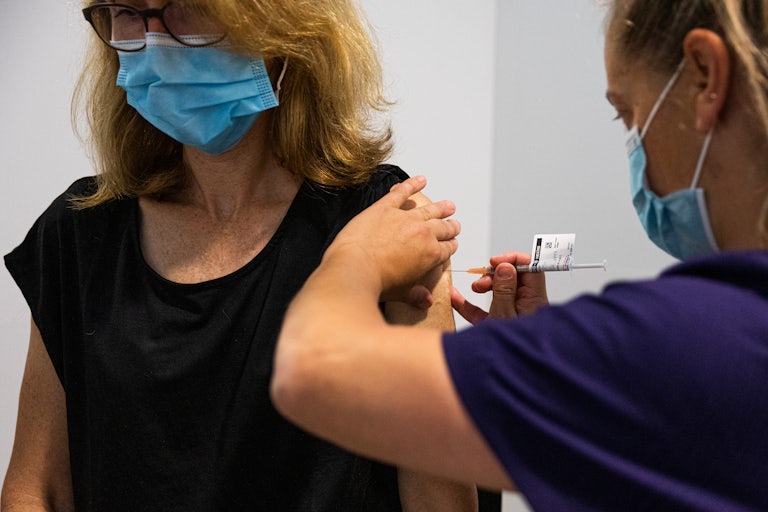 A nurse administers the AstraZeneca Covid-19 vaccine to a patient.