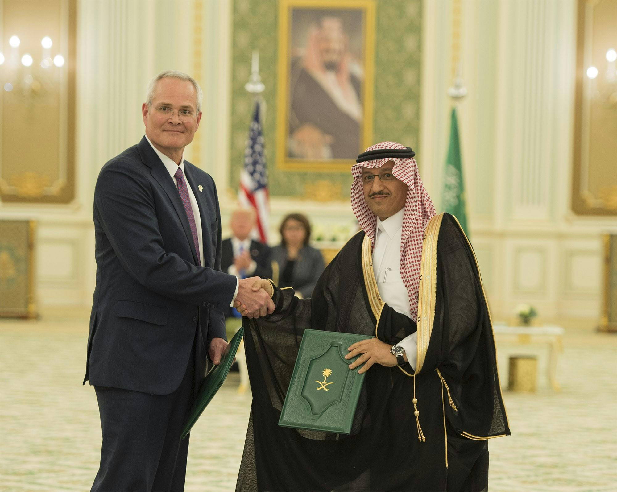 Darren Woods and Yousef Abdullah Al-Benyan shake hands.