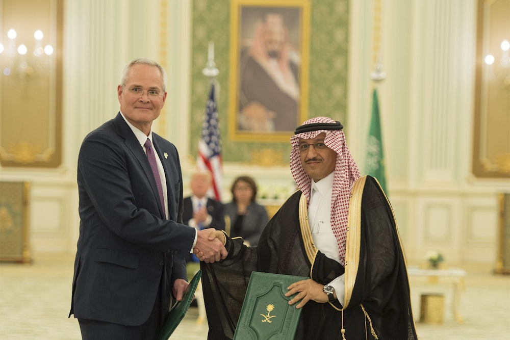 Darren Woods and Yousef Abdullah Al-Benyan shake hands.