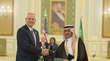 Darren Woods and Yousef Abdullah Al-Benyan shake hands.