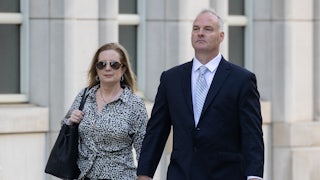 Michael McMahon walks outside court with a woman by his side.