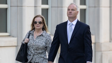 Michael McMahon walks outside court with a woman by his side.