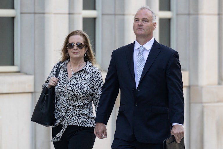 Michael McMahon walks outside court with a woman by his side.