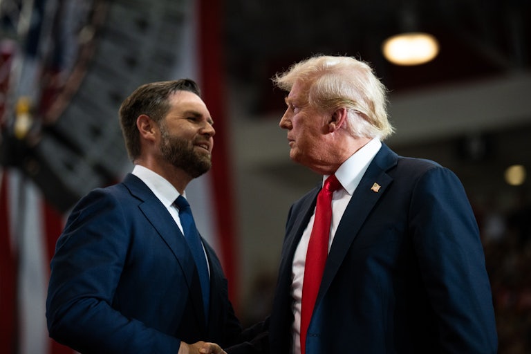 J.D. Vance and Donald Trump shake hands at a rally