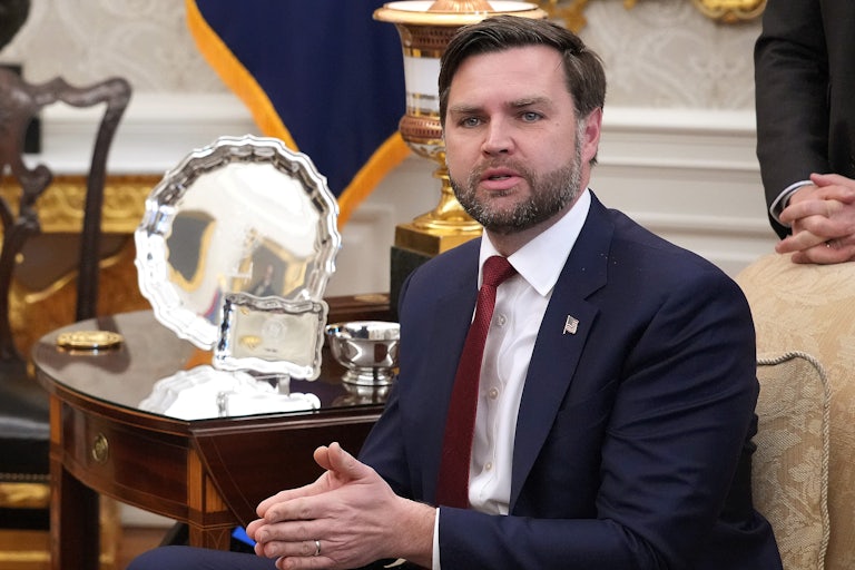 JD Vance puts his hands together while sitting in the Oval Office
