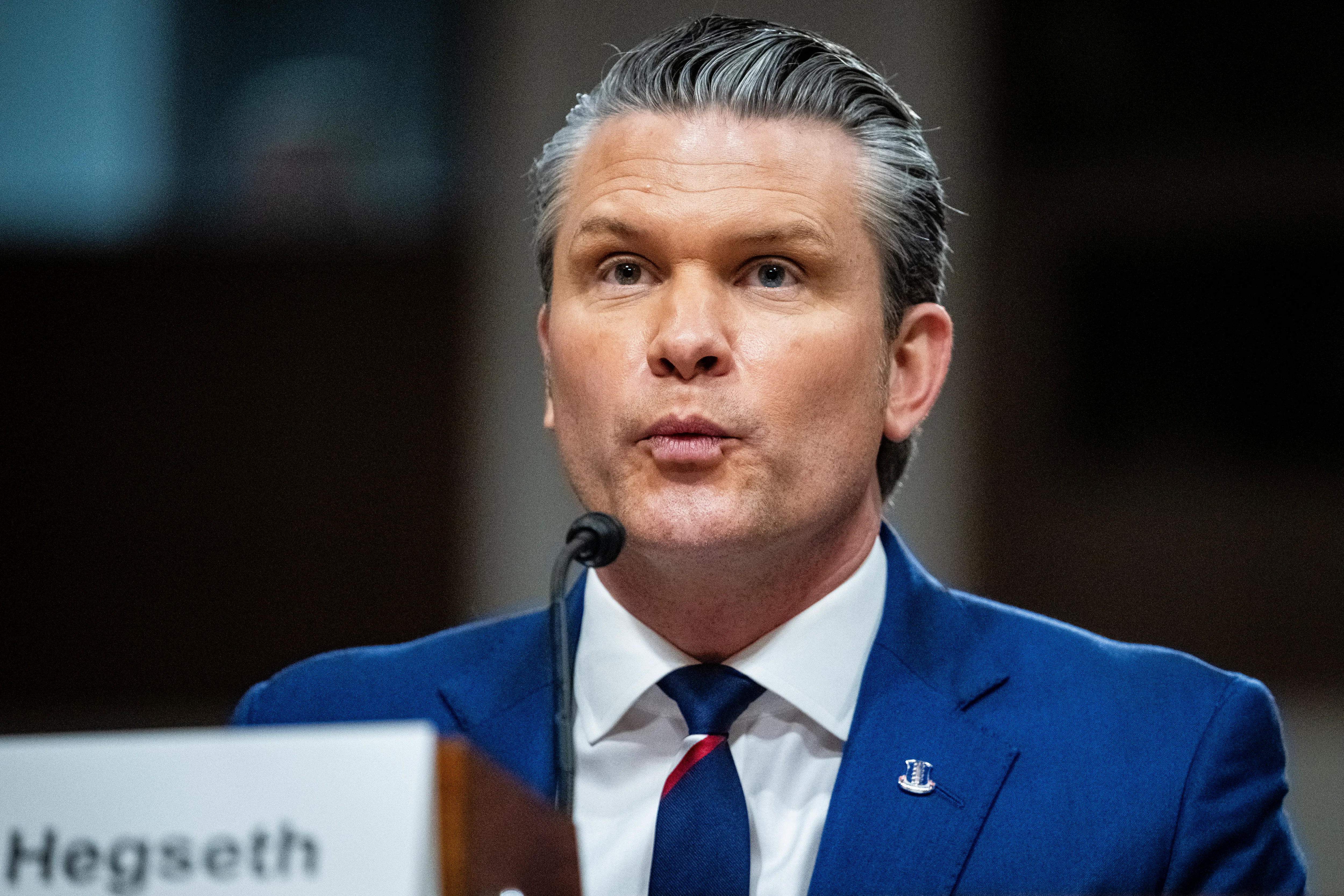 Defense Secretary Pete Hegseth puckers his lips while speaking during a Senate committee hearing