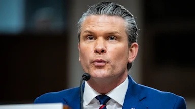 Defense Secretary Pete Hegseth puckers his lips while speaking during a Senate committee hearing