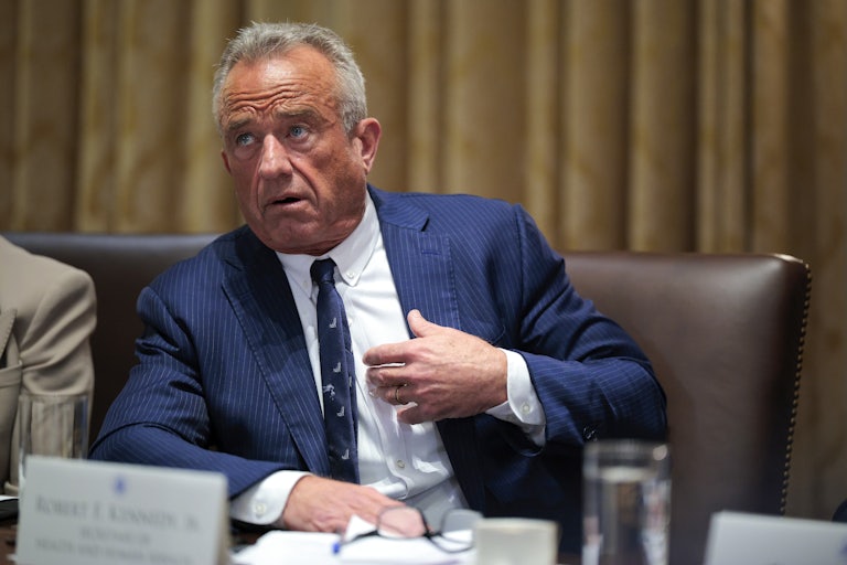 Robert F. Kennedy Jr. points to himself while speaking in a Cabinet meeting and leaning over slightly.